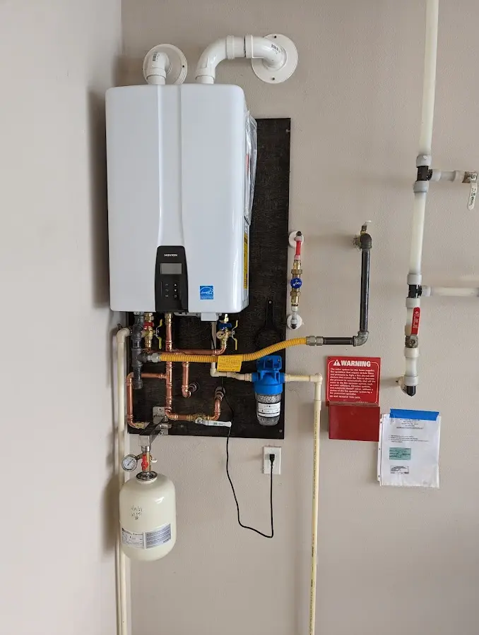 Professional plumber installing copper piping in a North Barrington home